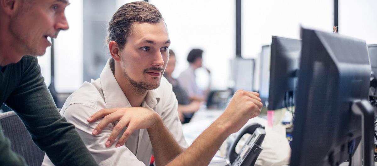 two men looking at monitors