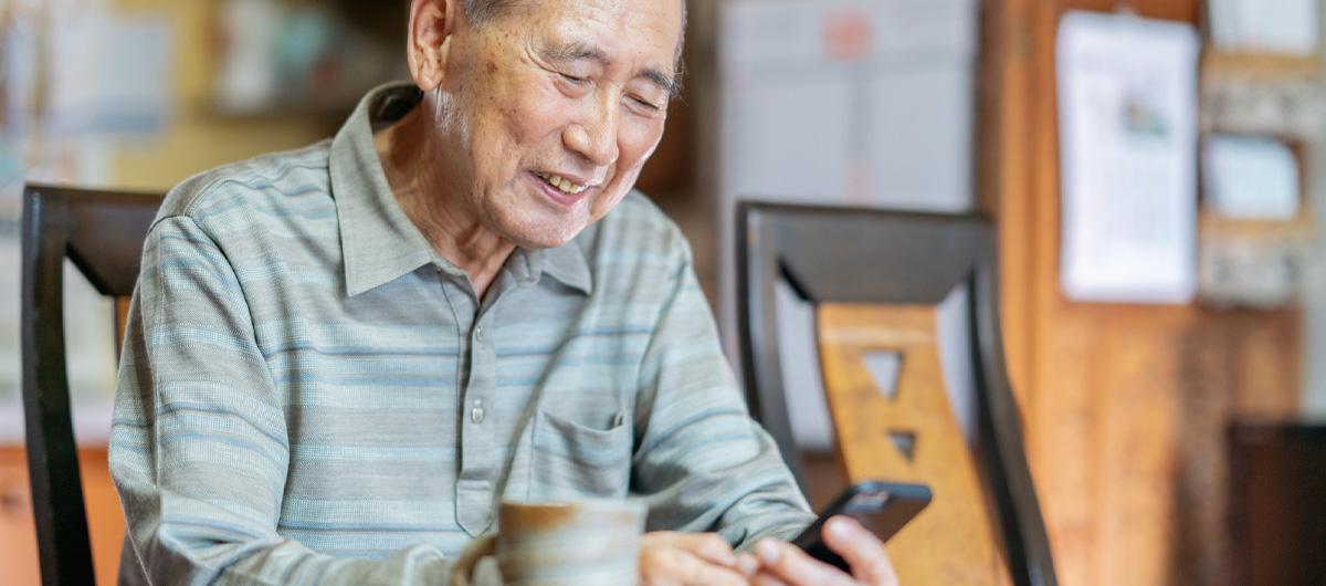 elderly man of asian ethnicity with phone