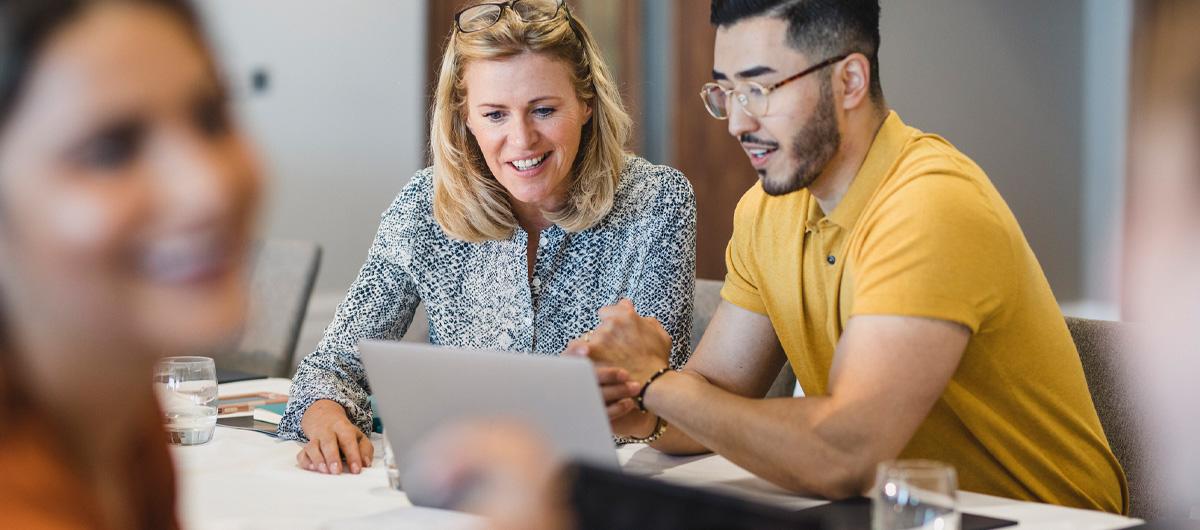 man and woman working on laptop