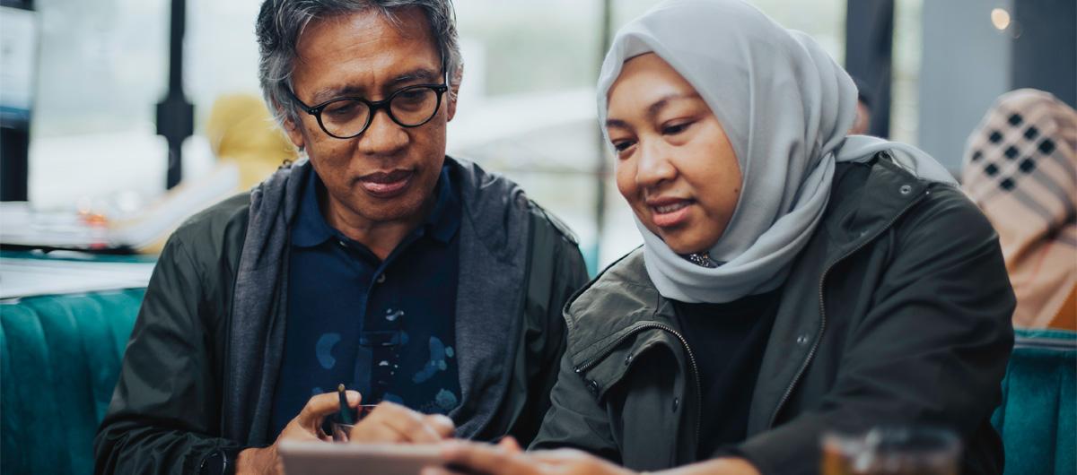 man and woman with hijab looking down