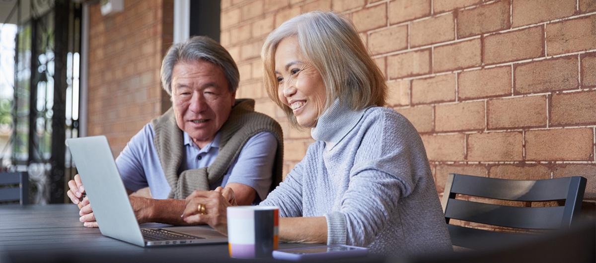 elderly couple on devices