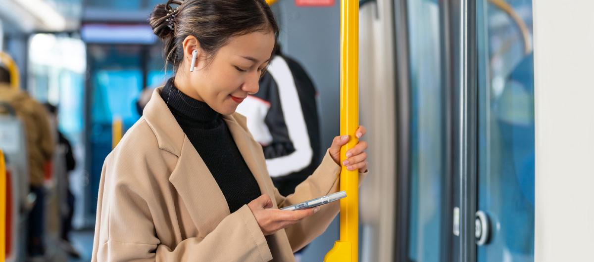 woman on train holding phone