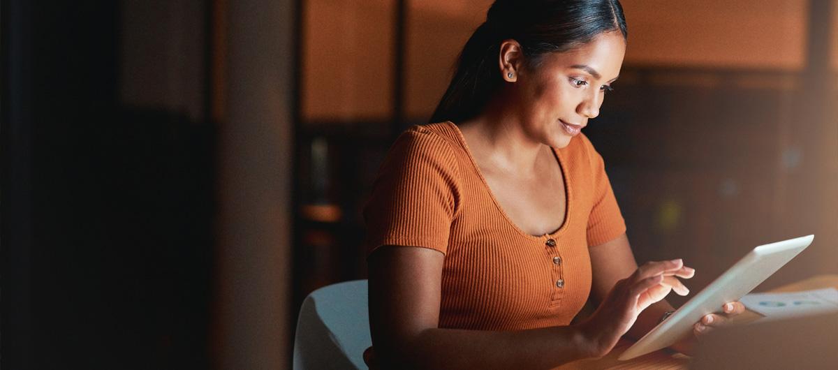 woman in orange on tablet