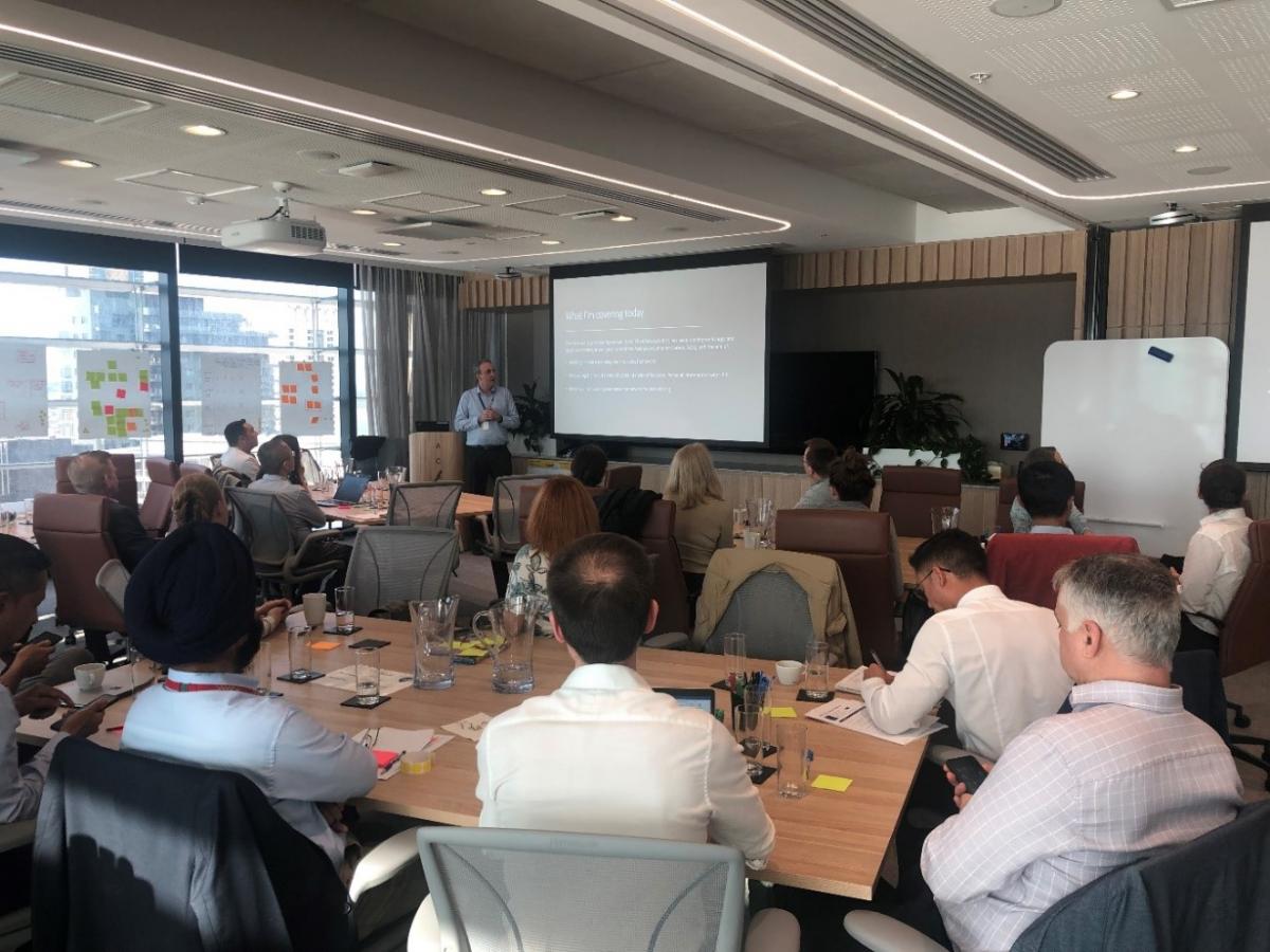 Photo of participants at the Data Champions meetup listening to a presentation