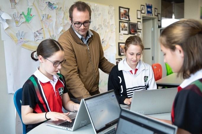 Students using devices with their teacher at Dubbo College South.